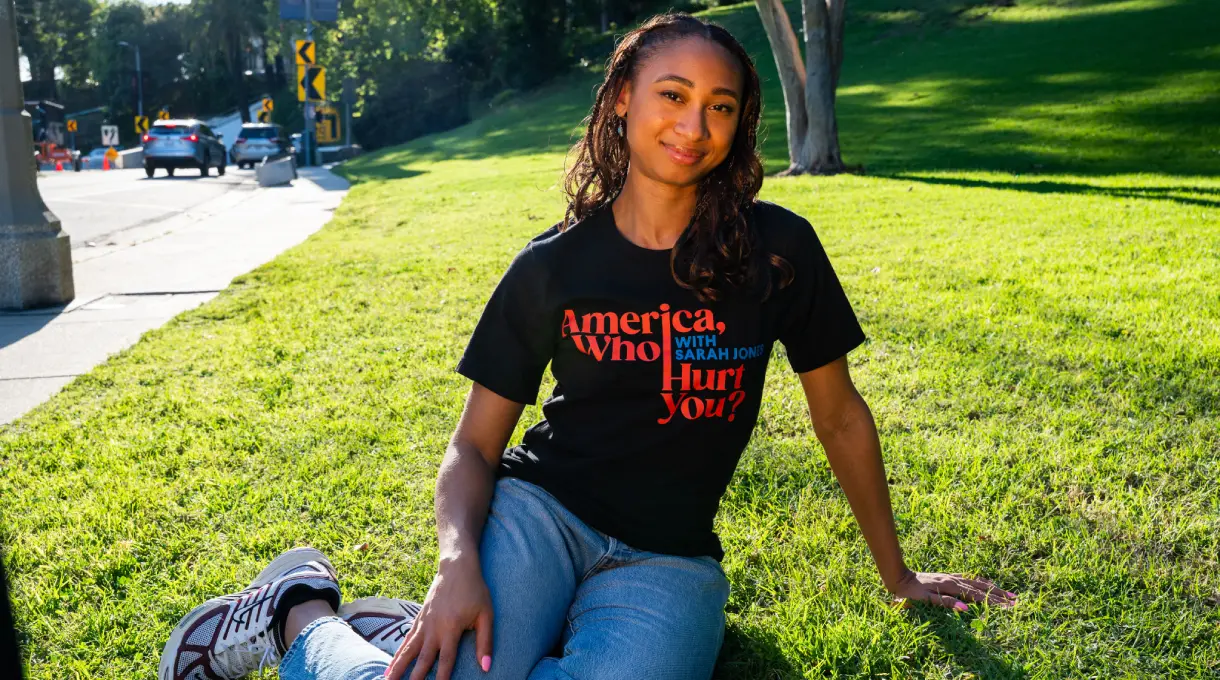 Woman in black graphic t-shirt on grass
